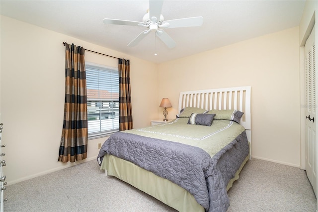 bedroom featuring ceiling fan, light carpet, and a closet