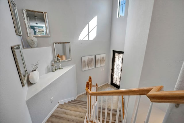 stairway featuring a high ceiling