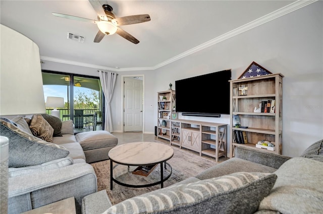 living room with ornamental molding and ceiling fan