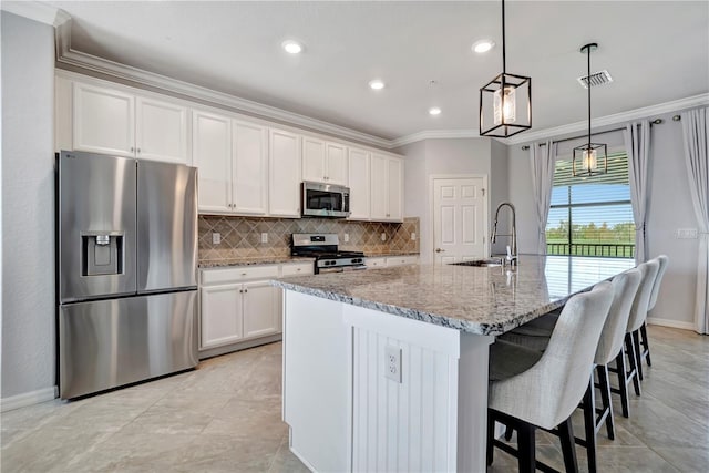 kitchen with white cabinetry, appliances with stainless steel finishes, and a kitchen island with sink