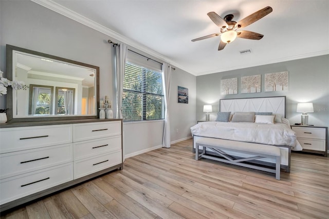 bedroom with crown molding, ceiling fan, and light hardwood / wood-style floors