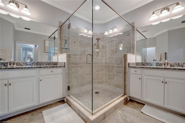 bathroom with vanity, ornamental molding, tile patterned floors, and a shower with shower door