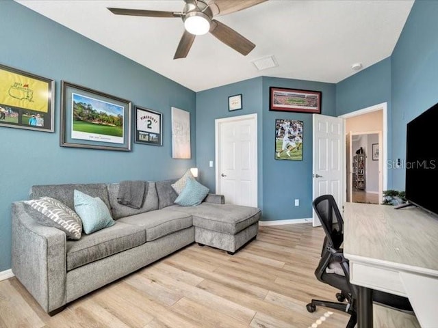 home office with ceiling fan and light hardwood / wood-style floors