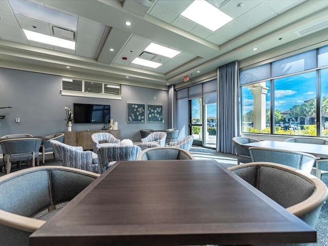 dining area featuring a towering ceiling