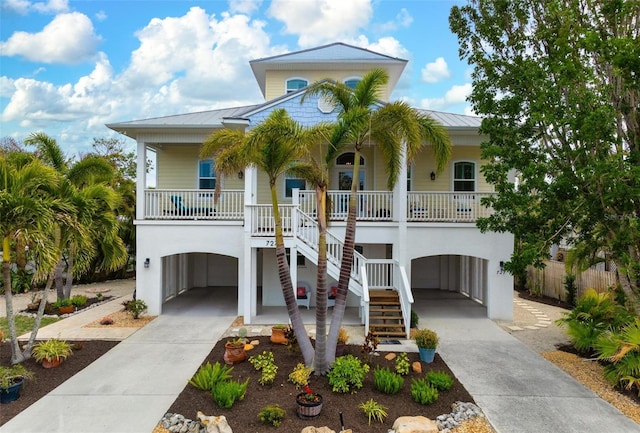 coastal inspired home featuring a porch and a carport