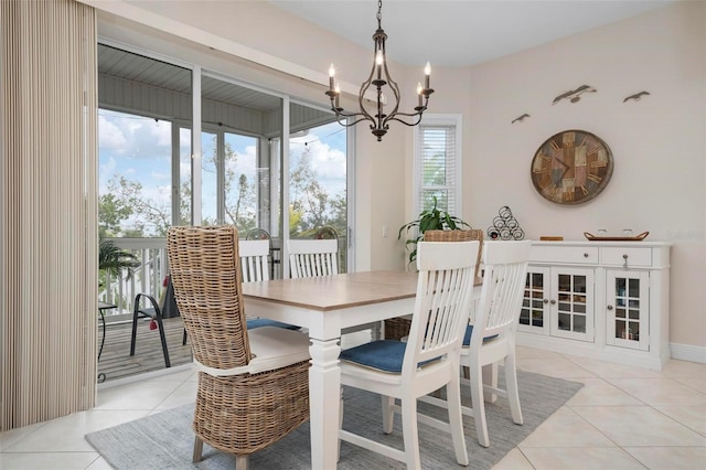 dining area with a notable chandelier and light tile patterned floors