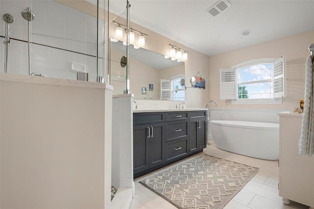 bathroom with vanity and separate shower and tub