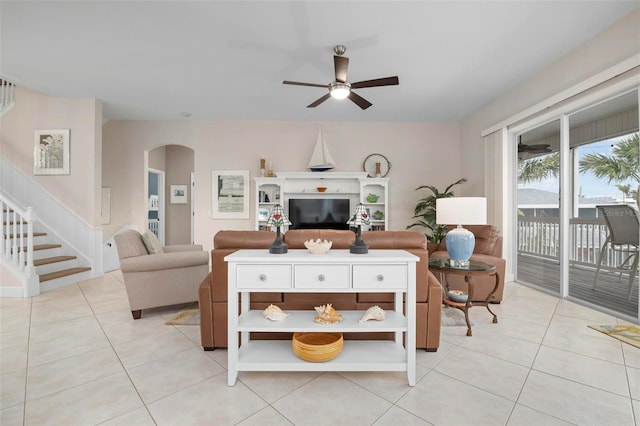 tiled living room featuring ceiling fan