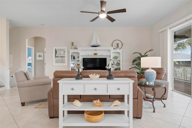 tiled living room with ceiling fan