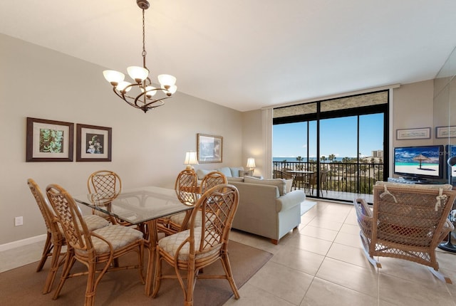 tiled dining room featuring an inviting chandelier and expansive windows