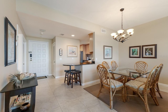 dining area featuring light tile patterned floors and a notable chandelier