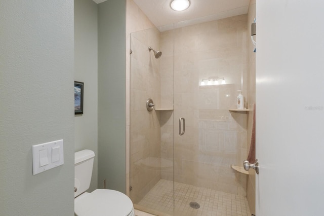 bathroom featuring toilet and an enclosed shower