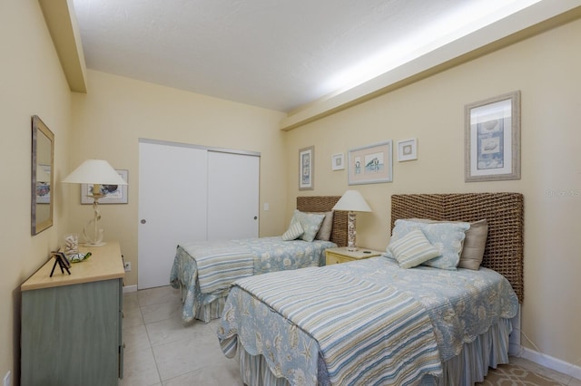 tiled bedroom featuring a closet