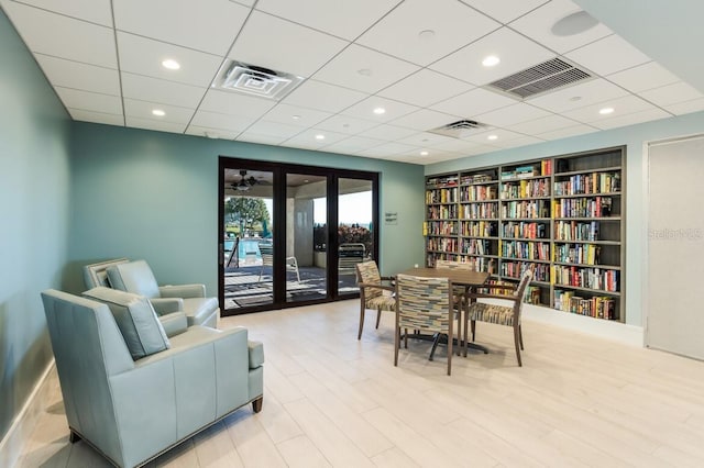 interior space featuring light wood-type flooring, built in features, and french doors