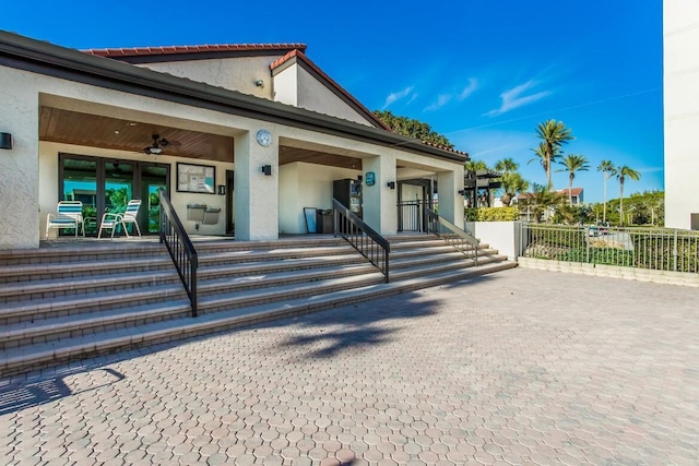 view of front of home with ceiling fan and a patio area