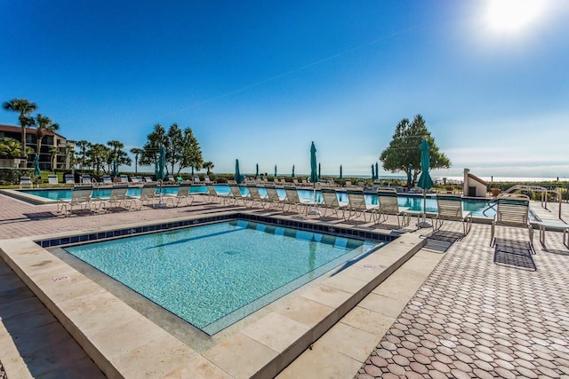 view of swimming pool featuring a patio area