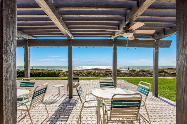 view of patio with ceiling fan and a water view