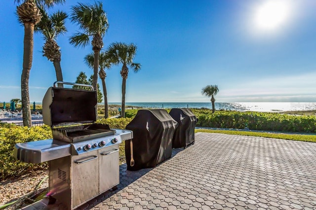 view of patio / terrace featuring area for grilling and a water view