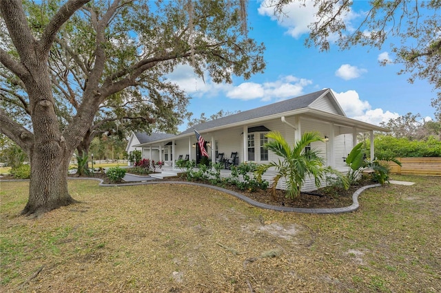 exterior space with a porch and a front yard