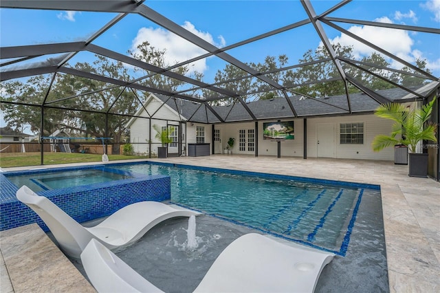 view of swimming pool with glass enclosure, an in ground hot tub, and a patio area