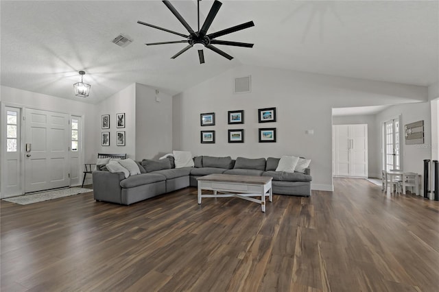 living room featuring ceiling fan, vaulted ceiling, and dark hardwood / wood-style floors