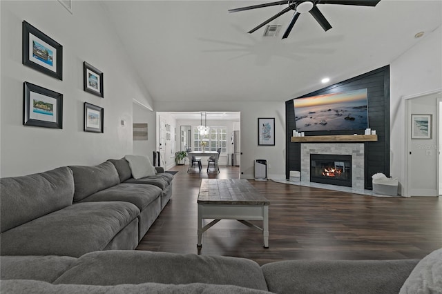 living room featuring a large fireplace, ceiling fan, dark hardwood / wood-style floors, and lofted ceiling