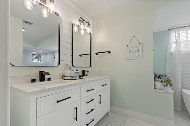 bathroom featuring vanity and a tub to relax in