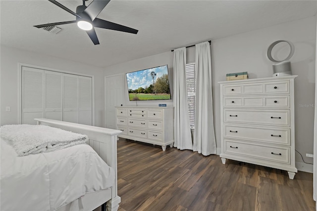 bedroom with ceiling fan, a closet, and dark hardwood / wood-style floors