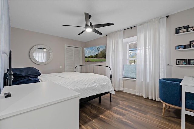 bedroom featuring ceiling fan, a closet, and dark hardwood / wood-style floors