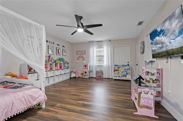 bedroom with ceiling fan and dark hardwood / wood-style flooring