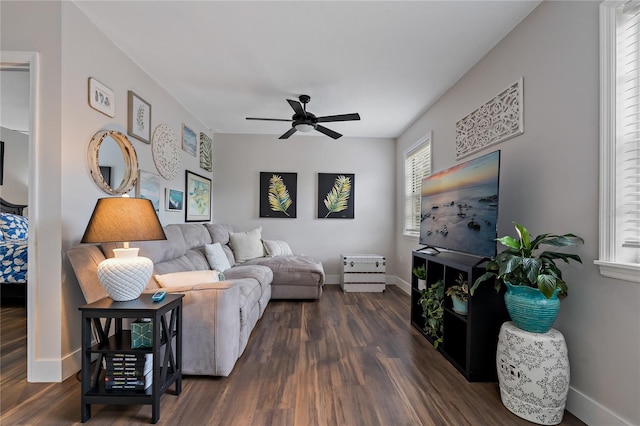 living room featuring ceiling fan and dark wood-type flooring