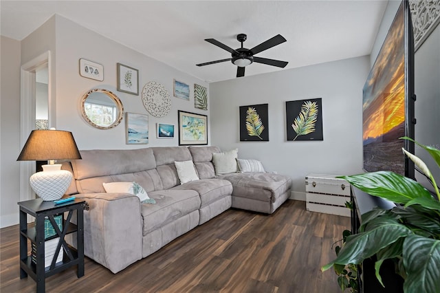 living room featuring ceiling fan and dark hardwood / wood-style floors