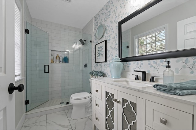 bathroom with toilet, an enclosed shower, and vanity