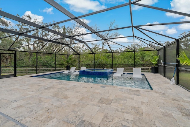 view of pool featuring glass enclosure, an in ground hot tub, and a patio area