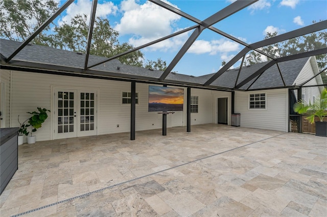 exterior space with french doors, glass enclosure, and a patio