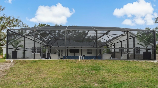 rear view of property with a lanai and a yard