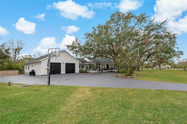 single story home with a garage and a front lawn