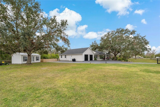 view of yard featuring an outbuilding and a garage