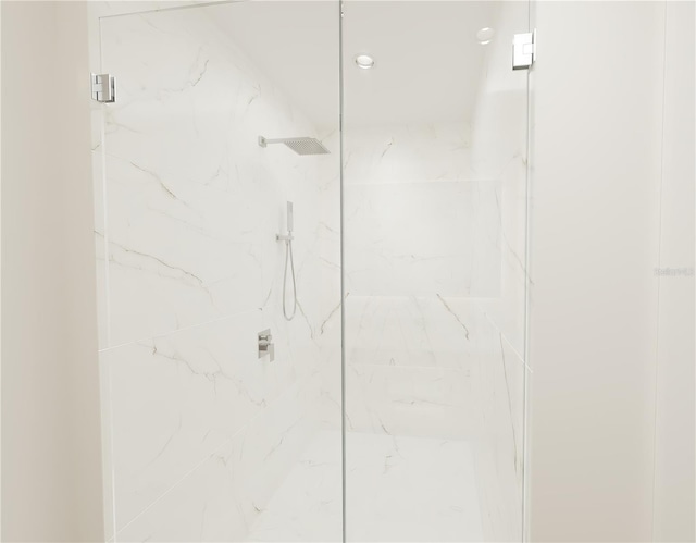 bathroom with a shower with shower door