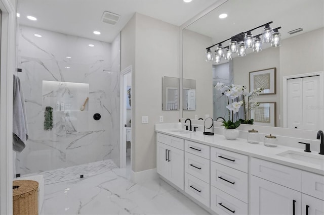 bathroom with vanity and tiled shower