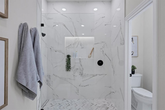 bathroom with toilet and a tile shower