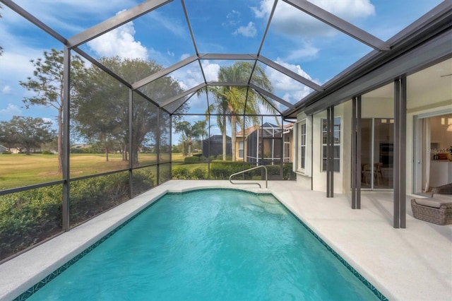 view of swimming pool with a lanai and a patio