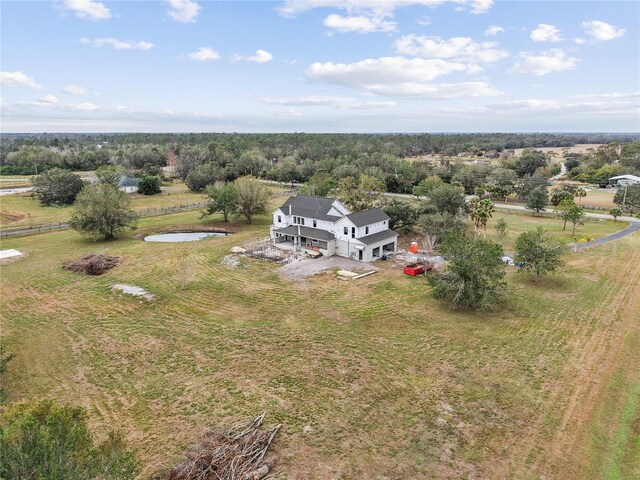 birds eye view of property featuring a rural view and a water view