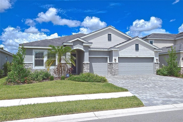 view of front facade with a front yard and a garage