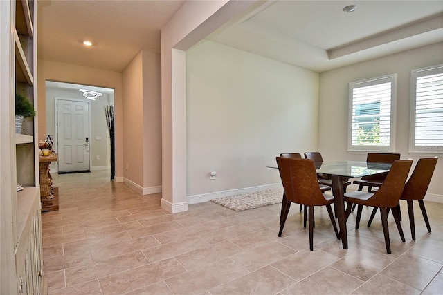 dining area featuring a raised ceiling