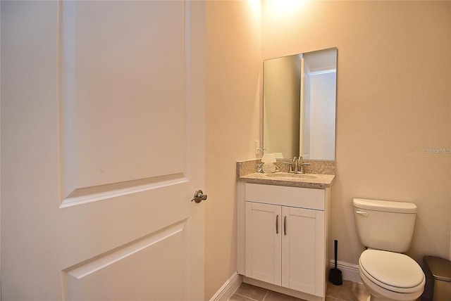 bathroom featuring toilet, vanity, and tile patterned flooring