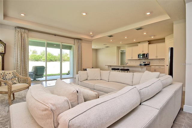 living room featuring a tray ceiling