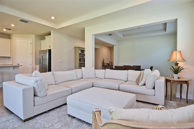 tiled living room with a raised ceiling