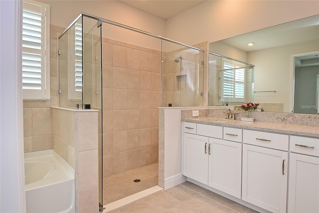 bathroom with vanity, tile patterned floors, and plus walk in shower