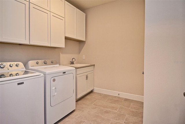 washroom with washing machine and dryer, cabinets, light tile patterned flooring, and sink